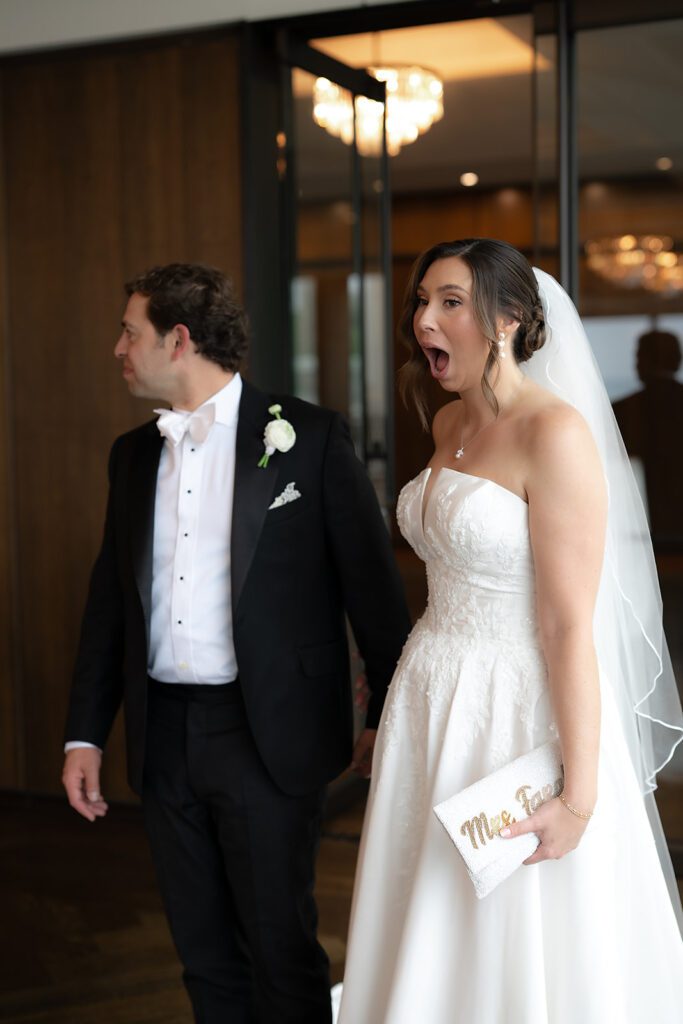 Couple walking hand in hand inside the Ballroom at The War Memorial in Grosse Pointe Farms for their reception room look.