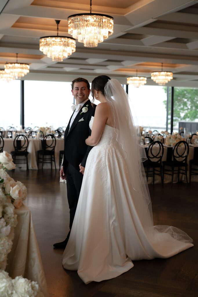 Couple admiring their reception inside the Ballroom at The War Memorial in Grosse Pointe for their first look of the room.