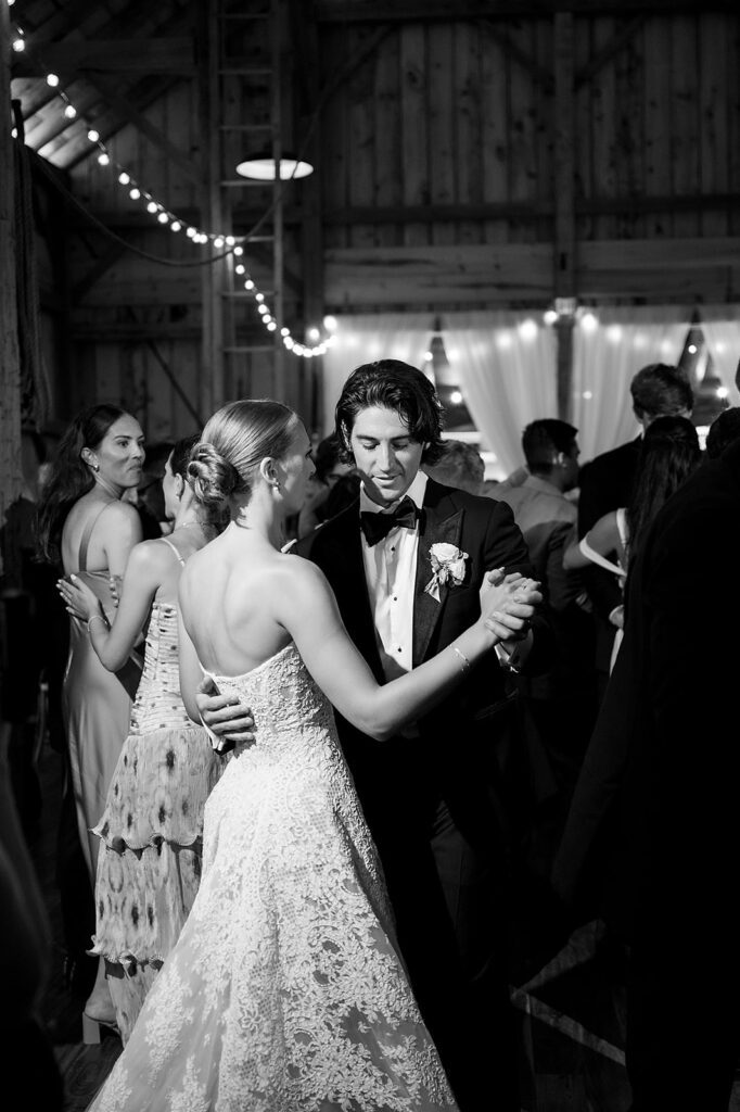Bride and groom dancing together during the reception at Noverr Farms wedding venue in Traverse City, Michigan.