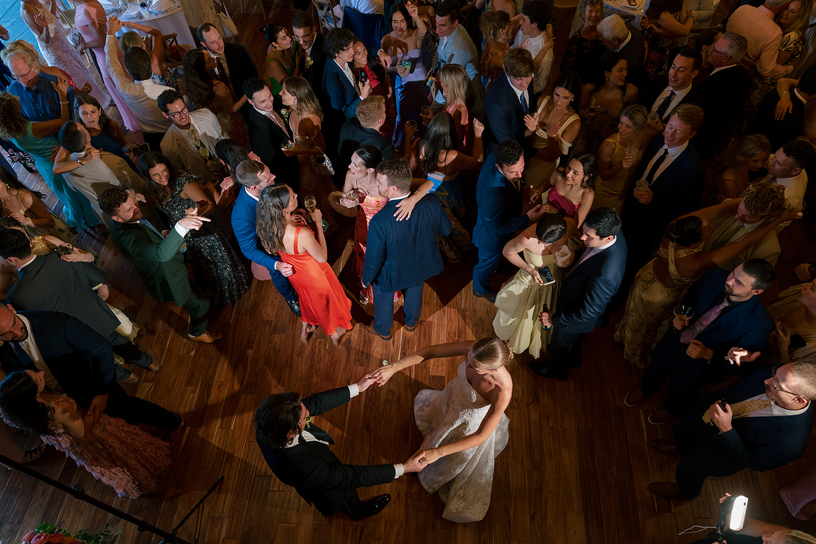 Overhead view of guests dancing during a lively Noverr Farms wedding reception in Traverse City, Michigan.