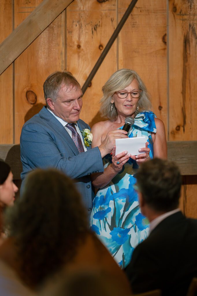Guests giving a heartfelt wedding toast during the reception at Noverr Farms in Traverse City, Michigan.