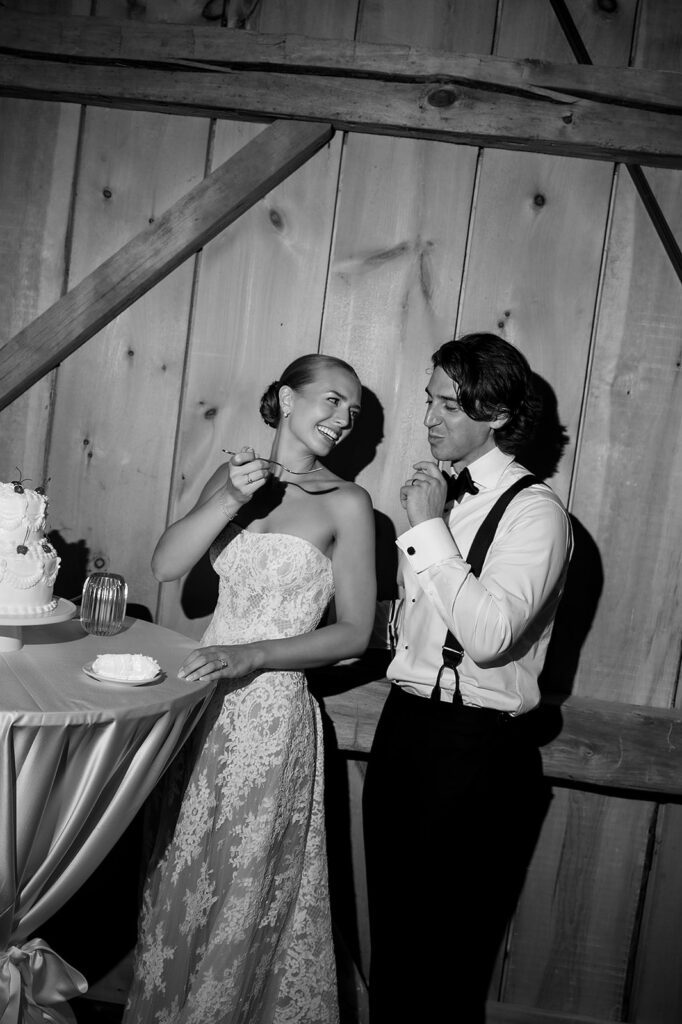 Bride and groom sharing cake during their wedding reception at Noverr Farms in Traverse City, Michigan.