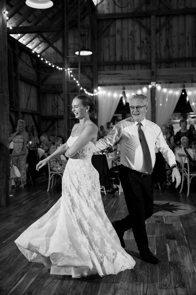 Bride dancing with her father during the wedding reception at Noverr Farms in Traverse City, Michigan.