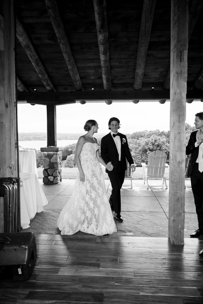Bride and groom entering the reception together at Noverr Farms in Traverse City, Michigan.