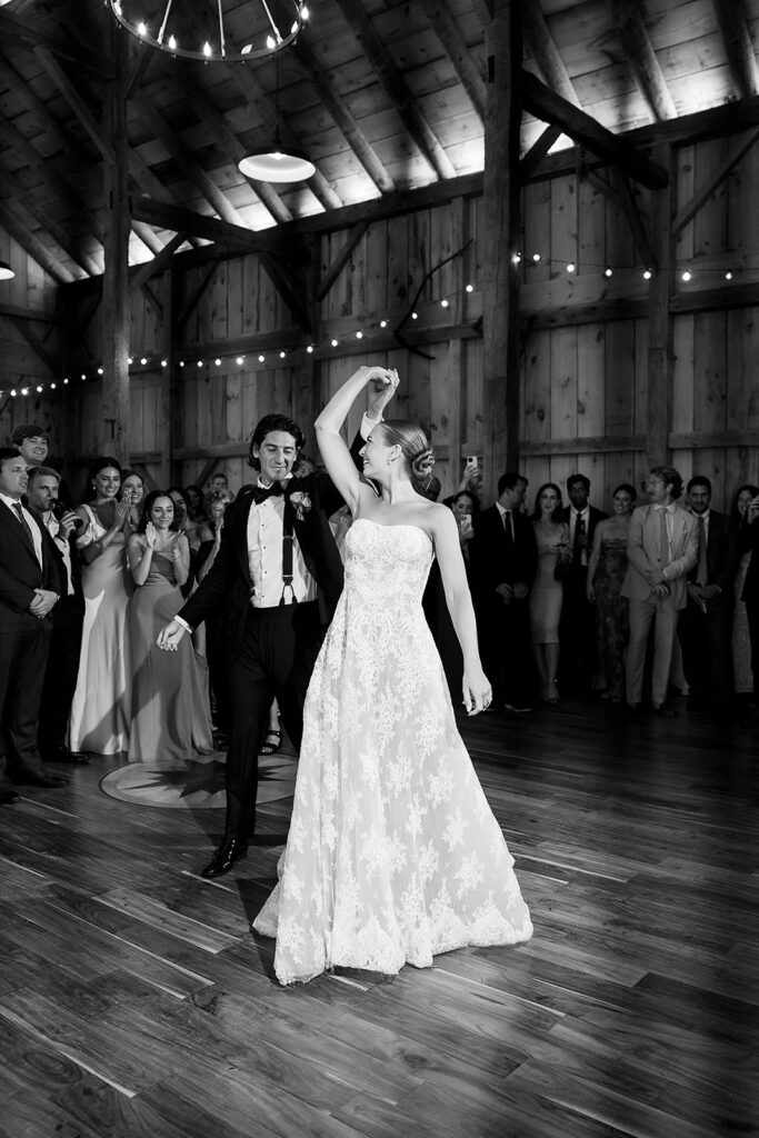 Bride and groom sharing their first dance inside the barn at Noverr Farms in Traverse City, Michigan.