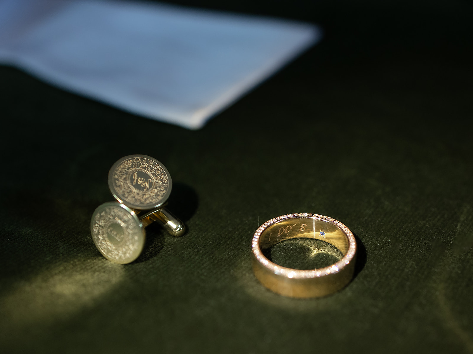 Close-up of the groom’s wedding band and engraved cufflinks photographed at the Shinola Hotel.