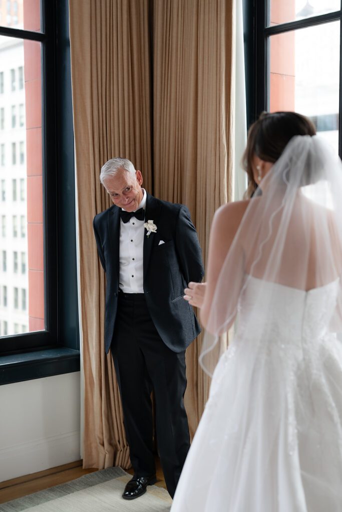 Emotional first look between the bride and her father during getting ready at the Shinola Hotel.