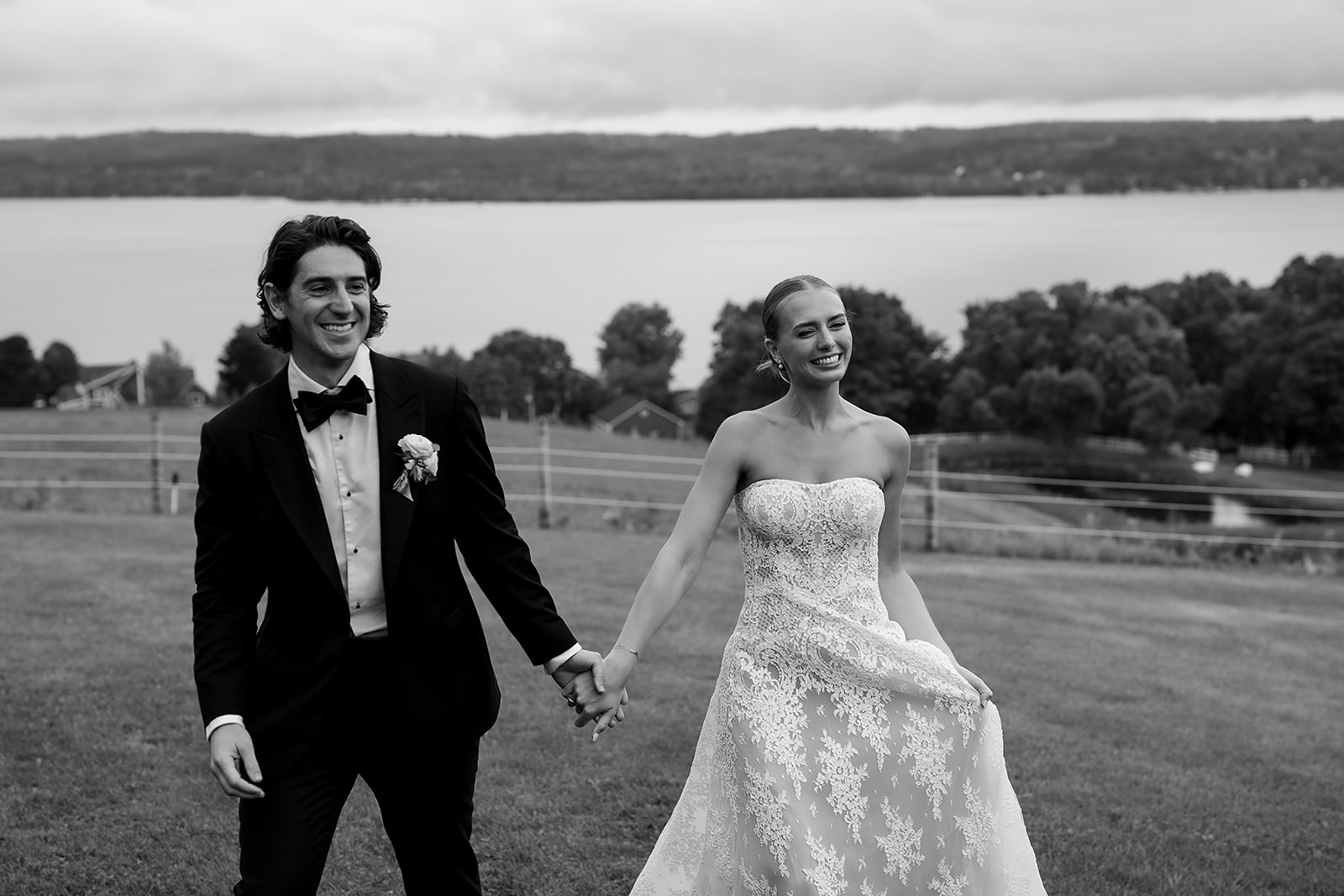Bride and groom walking hand in hand during portraits at Noverr Farms in Traverse City, Michigan.