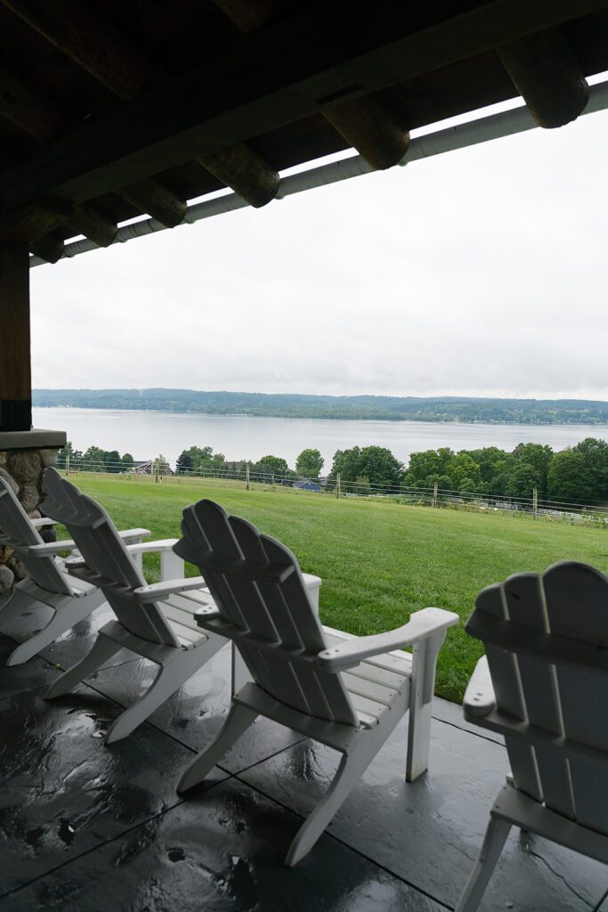 Adirondack chairs overlooking Lake Leelanau at Noverr Farms in Traverse City, Michigan during wedding cocktail hour.
