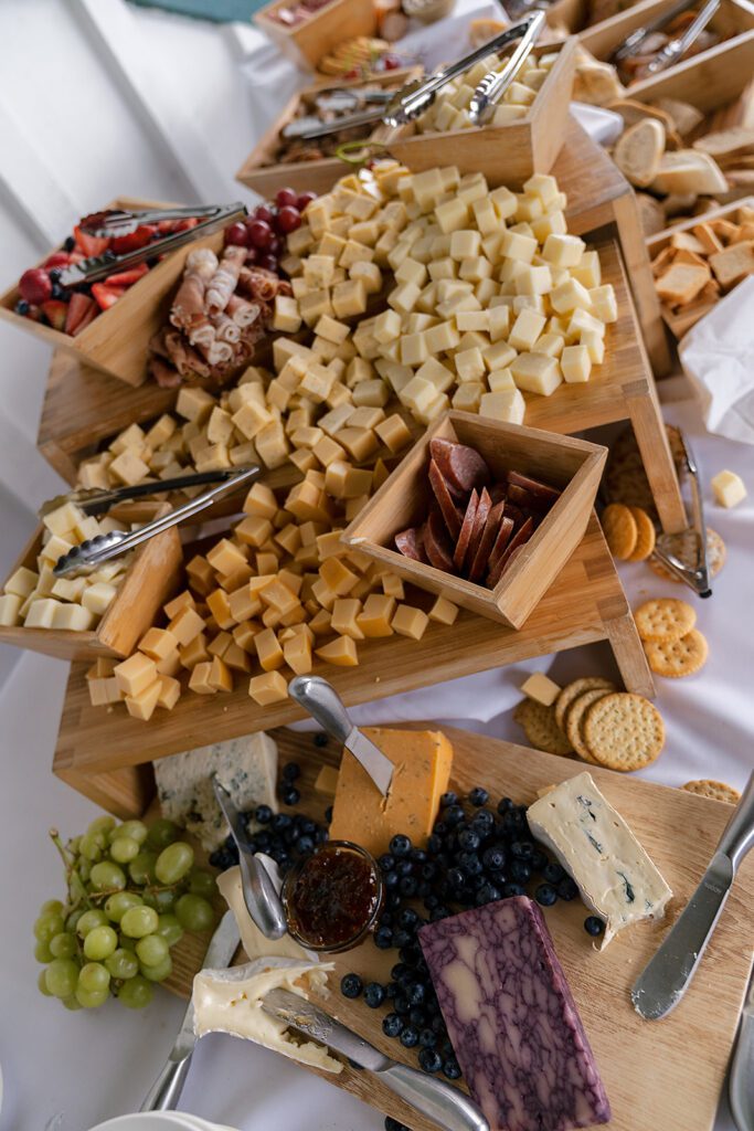 Cheese and charcuterie spread displayed during cocktail hour at a Noverr Farms wedding in Traverse City, Michigan.