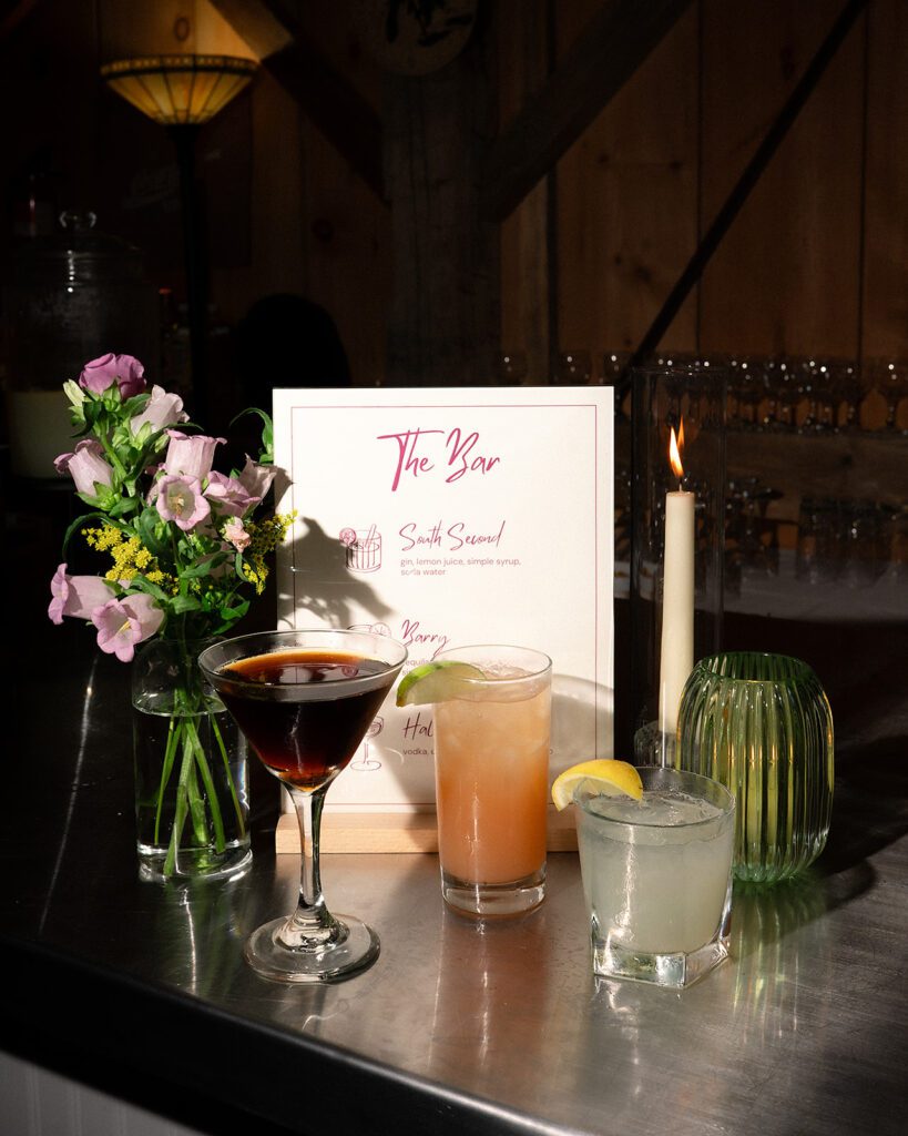 Signature cocktails displayed at the bar during a Noverr Farms wedding reception in Traverse City, Michigan.