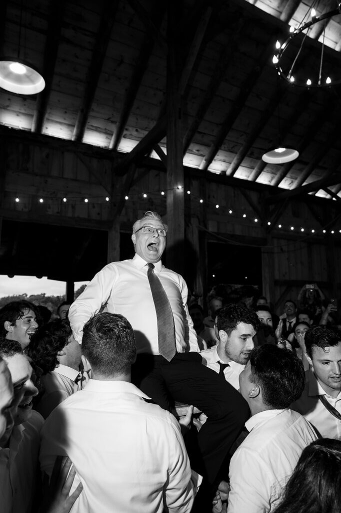 Man being lifted in the air during the reception.