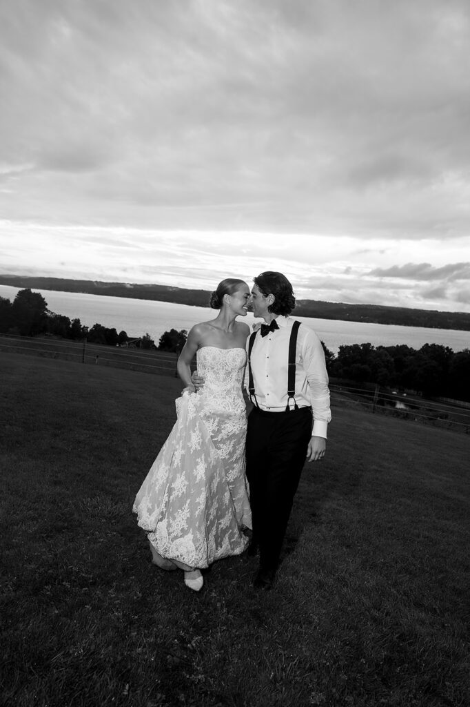 The couple laughing together during sunset portraits at their Traverse City wedding.