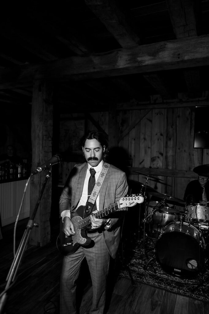 Man playing guitar during the reception.