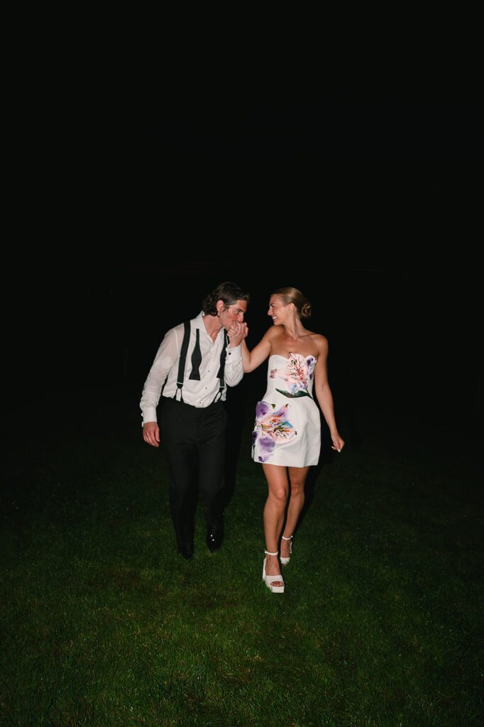 Bride and groom posing together in during their late-night reception at Noverr Farms.