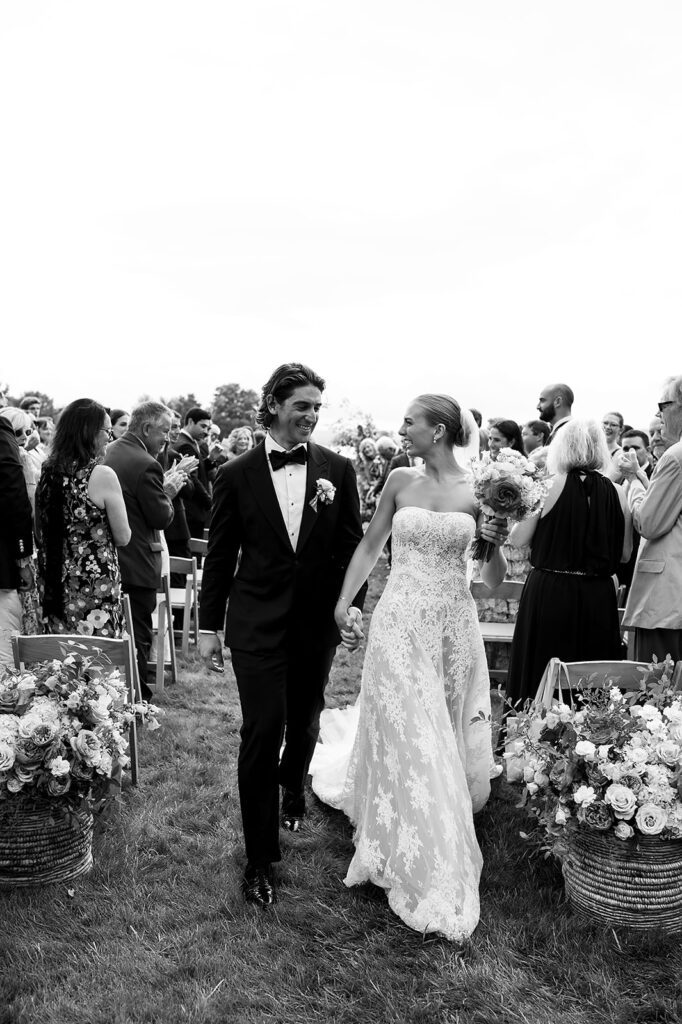 Bride and groom walking back down the aisle as husband and wife after their Noverr Farms wedding ceremony in Traverse City, Michigan.
