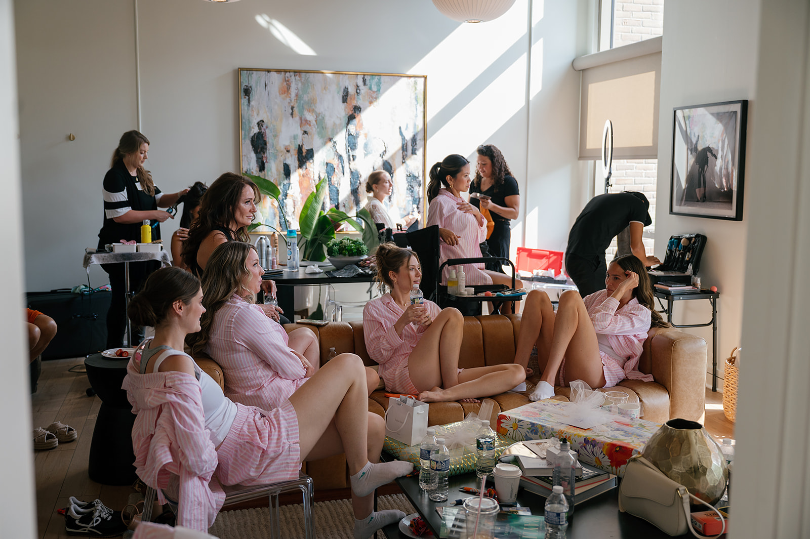 Candid photo of bridesmaids sitting together on a couch